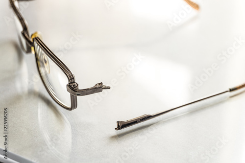 Eyeglasses with a broken shackle. Selective focus.