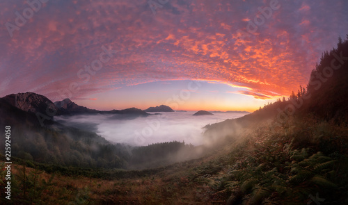 Colorful sunrise over Aramaiona valley under the fog in Alava photo