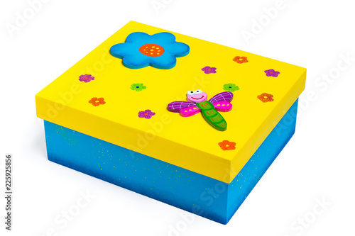 Isolated box with a little dragon-fly and floral print on the top with white background