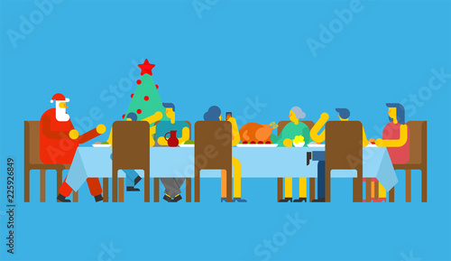Family Christmas dinner and Santa. Big table. Red caps. holiday lunch new year. Father and mother. Grandmother and grandfather. Relatives feast