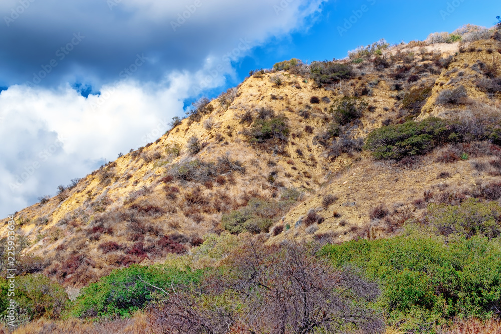 Rain clouds push up mountain side on autumn morning