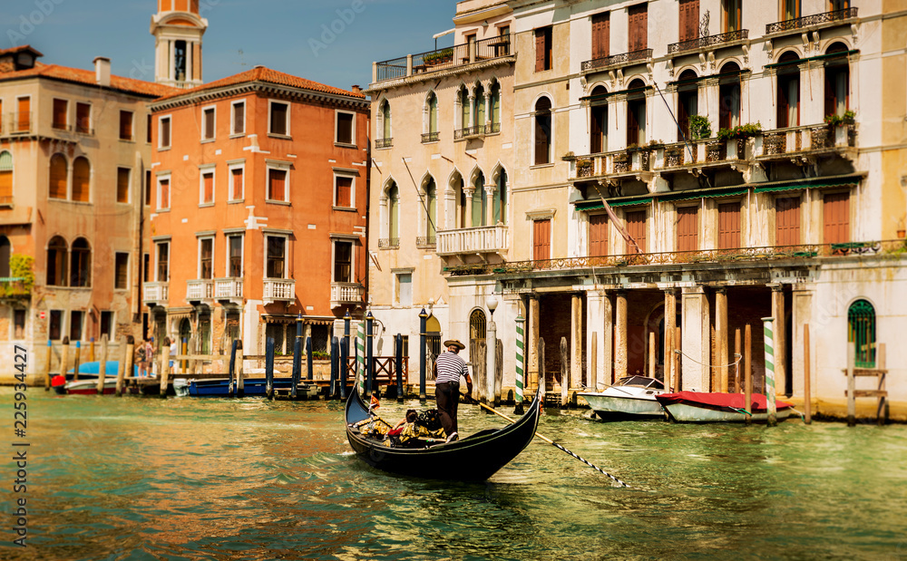 Naklejka premium Italy, Venice gondola, gondolier and colourful townhouses
