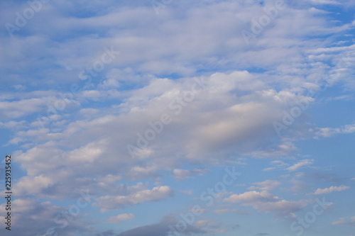 Fototapeta Naklejka Na Ścianę i Meble -  Blue sky and clouds in sunset light. Cloudscape photo background. Romantic skyscape with pink cloud.