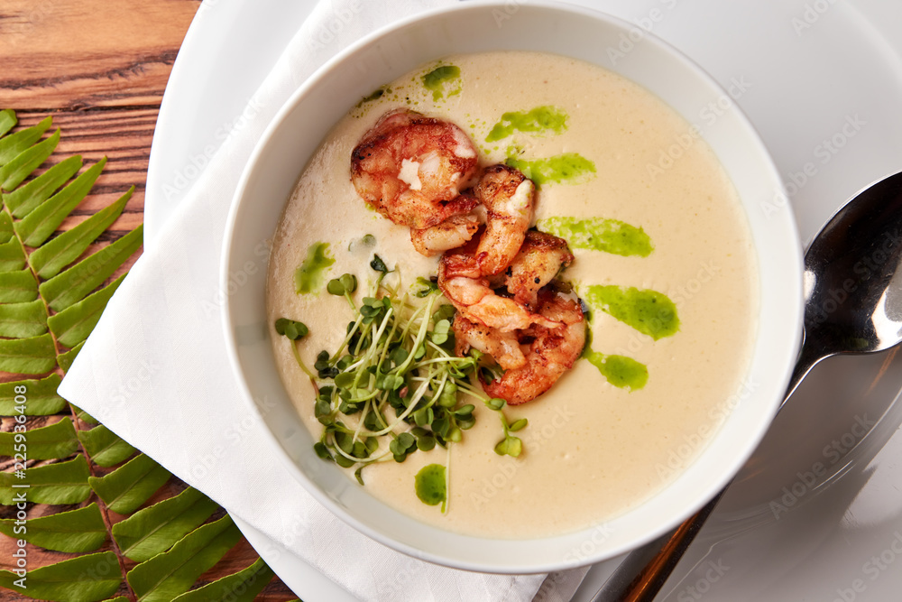 Creamy cheese soup with grilled shrimps