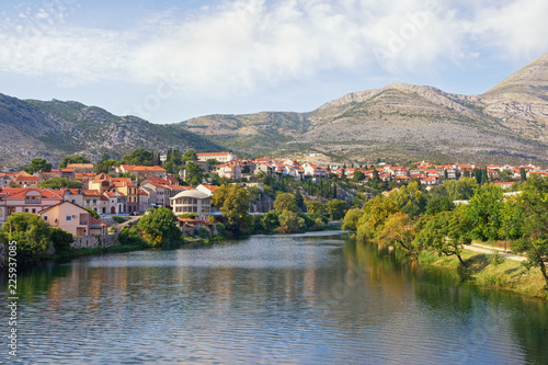 Picturesque landscape with town on river bank. Bosnia and Herzegovina, Republika Srpska. View of Trebisnjica river and Trebinje town, autumn
