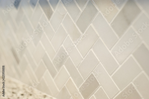Fotografie Close detail of a new small tile herringbone pattern professionally installed in a home kitchen