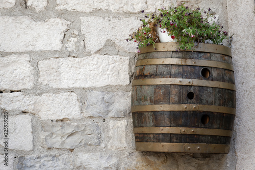 Wine barrel on the wall of the building. © konik60