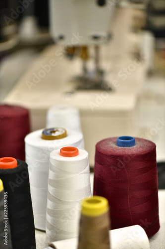 Spools of Colored Thread and sewing machine in the background