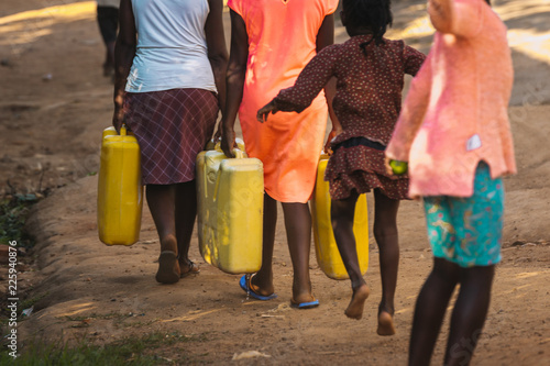 Fotografie Women carrying water can in Uganda, Africa
