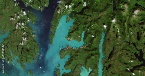 Very high-altitude overflight aerial of archipelago of Prince of Wales Island, Alaska. Clip loops and is reversible. Elements of this image furnished by USGS/NASA Landsat photo