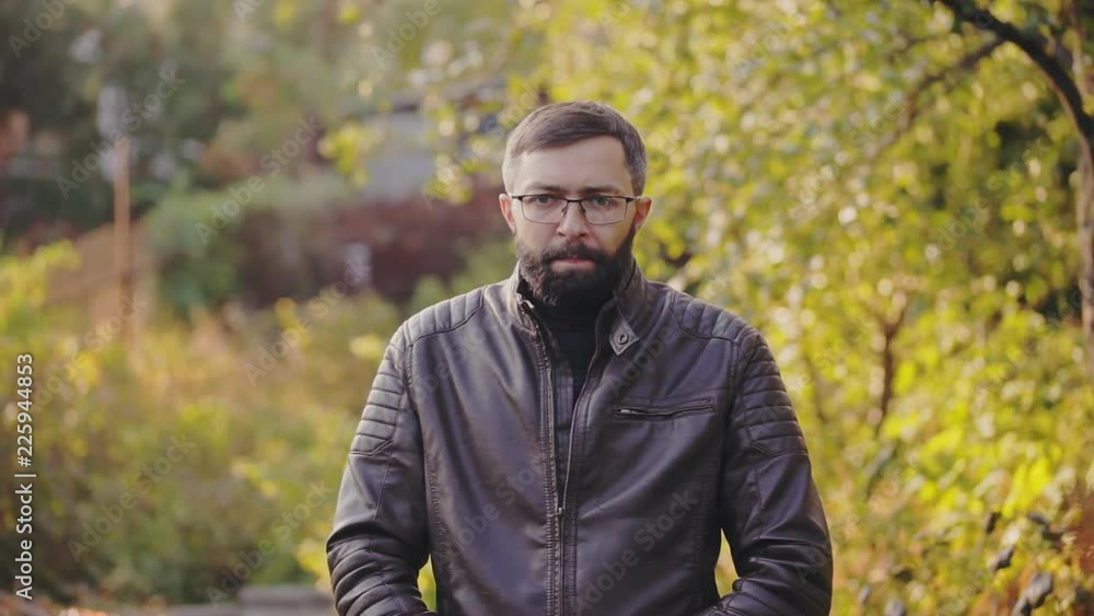 Bearded man sneezes in autumn park, allergy Bearded man sneezes in autumn park, allergy