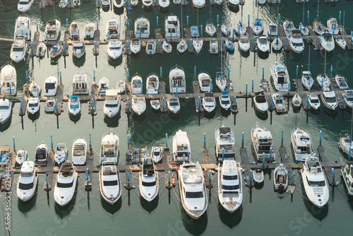 Yatch harbor marina pier and boat dock yatchs and vessels awaiting the open sea. Aerial drone view looking straight down above T-Head..