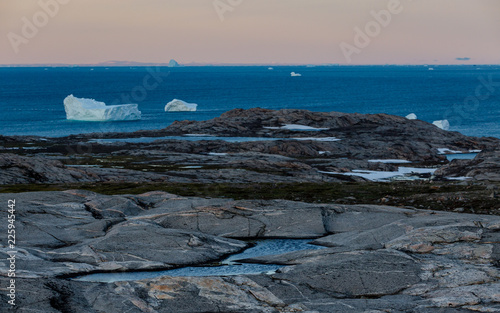 Arctic landscape with iceberg at sunset photo