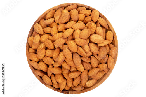 Almonds in wooden dish on white background.