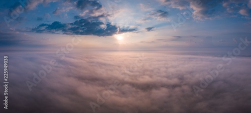 Beautiful foggy sunrise panoramic landscape from drone.