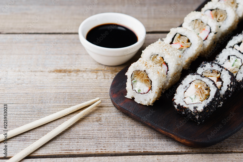 Tasty traditional food, Japanese culture. Sushi rolls with crab meat, cucumber and cream cheese, covered with sesame, restaurant serving Tasty traditional food, Japanese culture. Sushi rolls with crab meat, cucumber and cream cheese, covered with sesame, restaurant serving