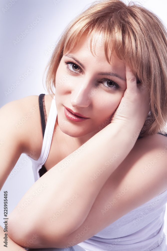 Portrait of Calm and Tranquil Dreaming Caucasian Blond Woman in Casual Clothing. Posing Against White Portrait of Calm and Tranquil Dreaming Caucasian Blond Woman in Casual Clothing. Posing Against White