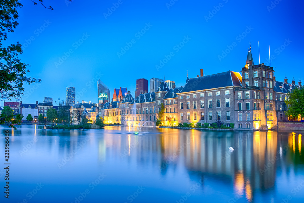 Travel Concepts. Binnenhof Palace of Parliament in The Hague in The Netherlands at Blue Hour. Against Modern Skyscrapers on Background.