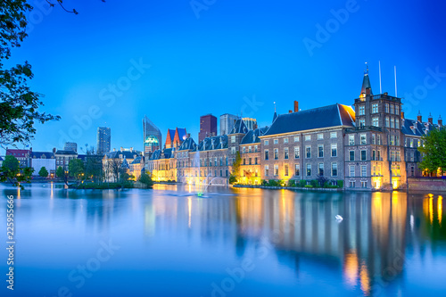 Travel Concepts. Binnenhof Palace of Parliament in The Hague in The Netherlands at Blue Hour. Against Modern Skyscrapers on Background.