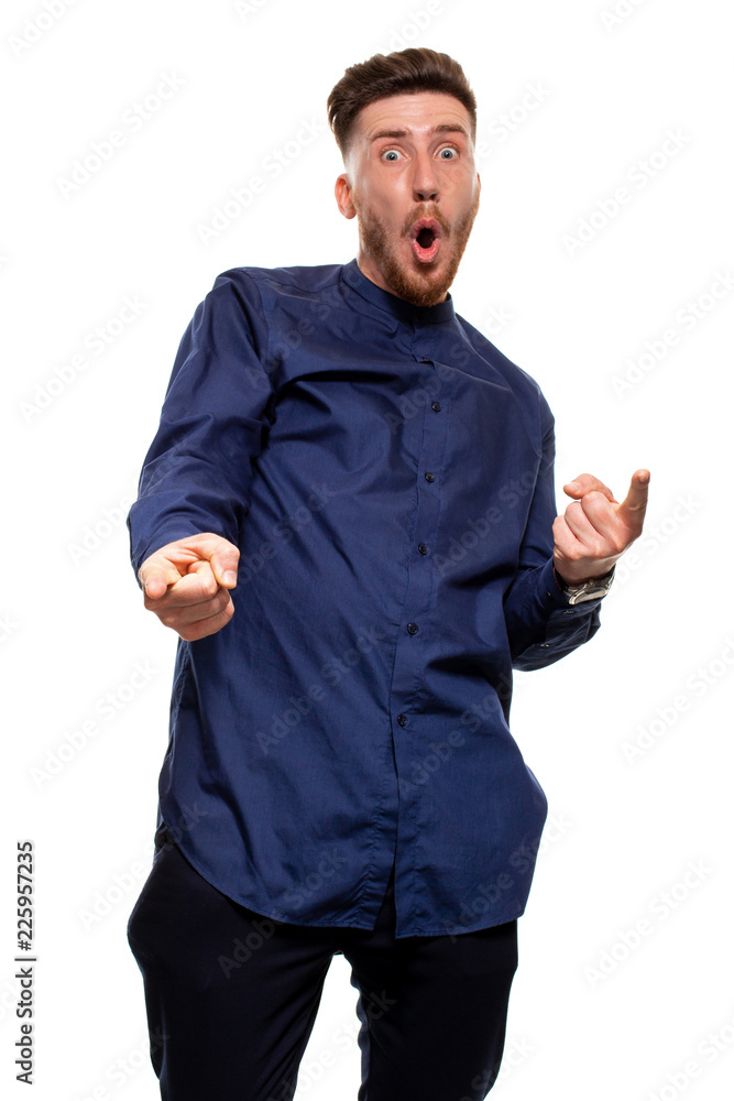 Vertical shot of stupefied stunned shocked young male keeps mouth widely opened, being surprised and very emotional, expresses great surprisment. Vertical shot of stupefied stunned shocked young male keeps mouth widely opened, being surprised and very emotional, expresses great surprisment.