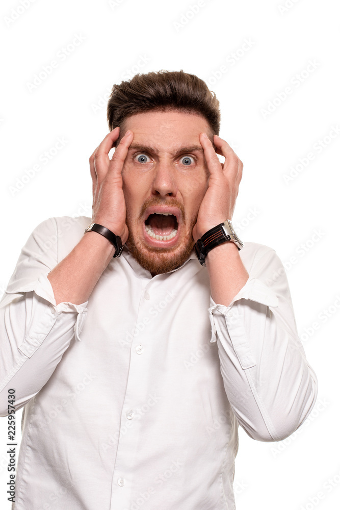 Vertical shot of stupefied stunned shocked young male keeps mouth widely opened, being surprised and very emotional, expresses great surprisment. Vertical shot of stupefied stunned shocked young male keeps mouth widely opened, being surprised and very emotional, expresses great surprisment.