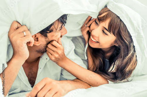 Happy young couple relaxing in the home bedroom. photo