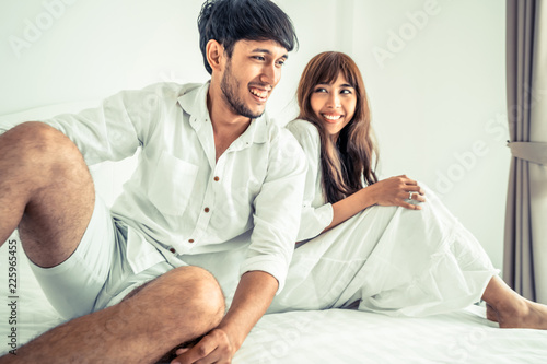 Happy young couple relaxing in the home bedroom. photo