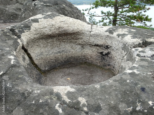 Bowl in the granite rock. Rock massif Arakulsky Sheehan Chelyabinsk region, Russia photo