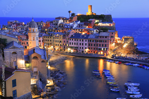 Aerial view of Vernazza vilagge illuminated at dusk on Mediterranean coast, Cinque Terre, Italy photo