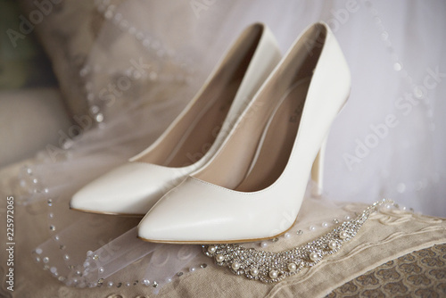 Wedding bridal shoes in the interiors close-up in beige tones.The collection of the bride.