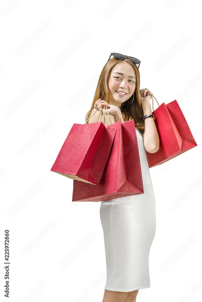 Smiling asian girl holding colored shopping bags