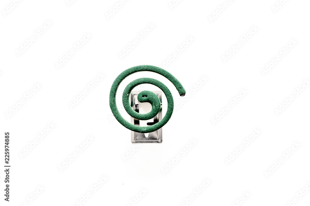 Mosquito repellent for outdoor: garden, summer house, picnic. Green spiral on white background top view space for text Mosquito repellent for outdoor: garden, summer house, picnic. Green spiral on white background top view space for text