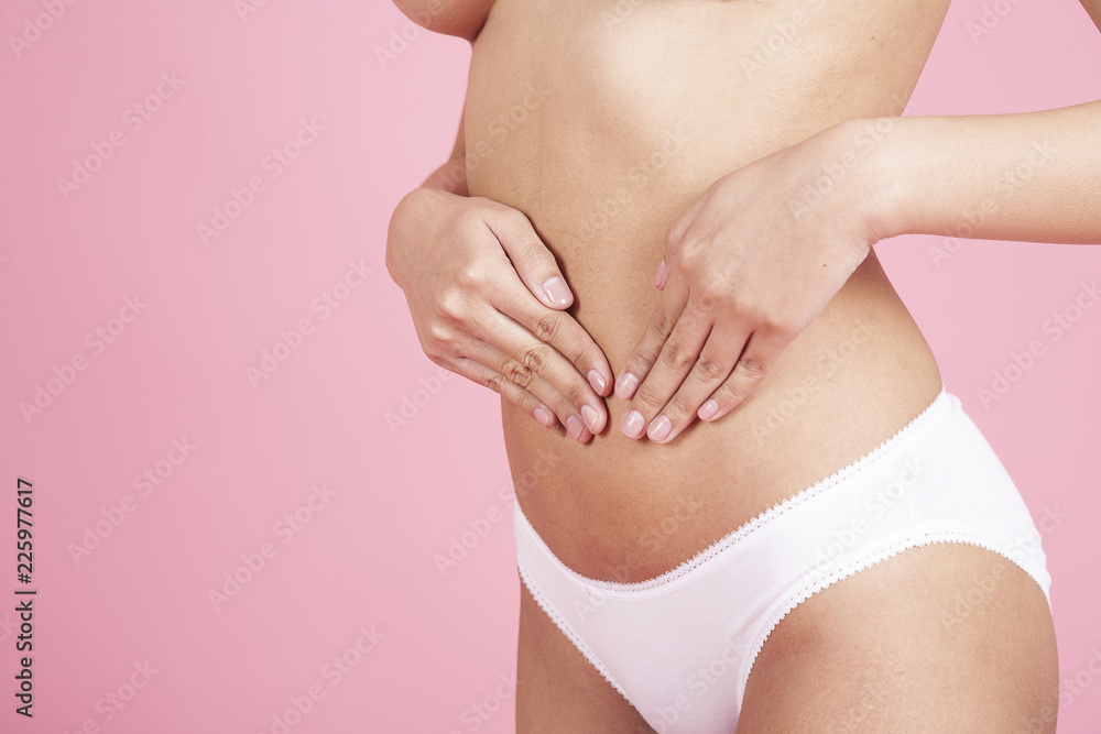 close up woman checks or touching beauty, body care on pink background. Overweight Beauty medical and Health care Concept.