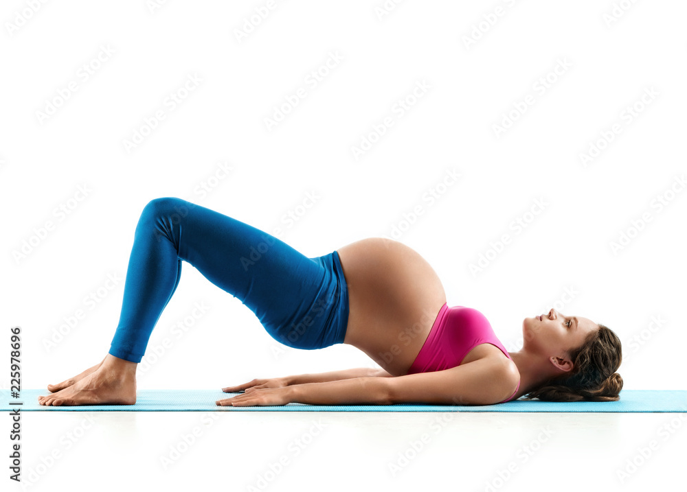Pregnant woman does yoga exercise on last months of pregnancy isolated on white background. Concept of healthy life Pregnant woman does yoga exercise on last months of pregnancy isolated on white background. Concept of healthy life