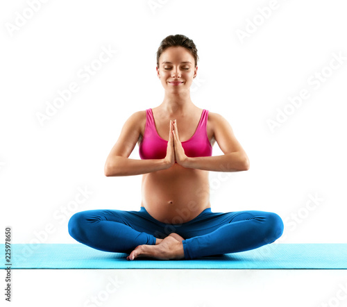 Pregnancy woman doing yoga practice isolated on white background. Concept of healthy life