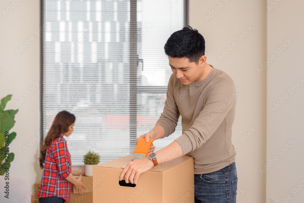 Happy couple moving into a new apartment. Happy couple moving into a new apartment.
