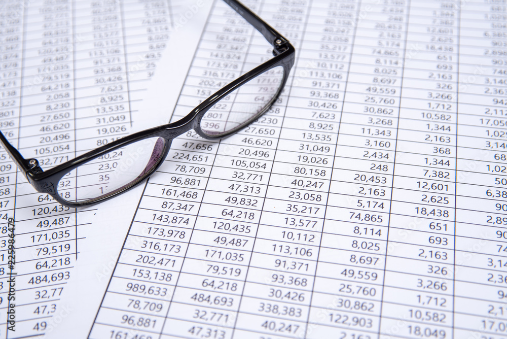 A glasses on financial chart, business concept. A glasses on financial chart, business concept.