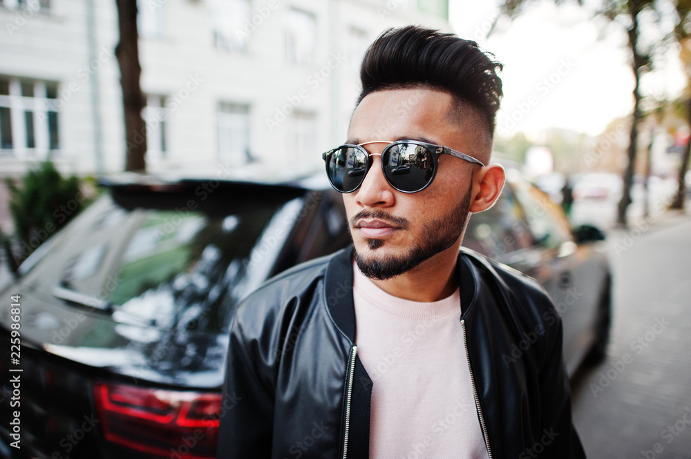 Stylish indian beard man at black leather jacket and sunglasses against  business suv car. India model posed outdoor at streets of city. Stock Photo  | Adobe Stock