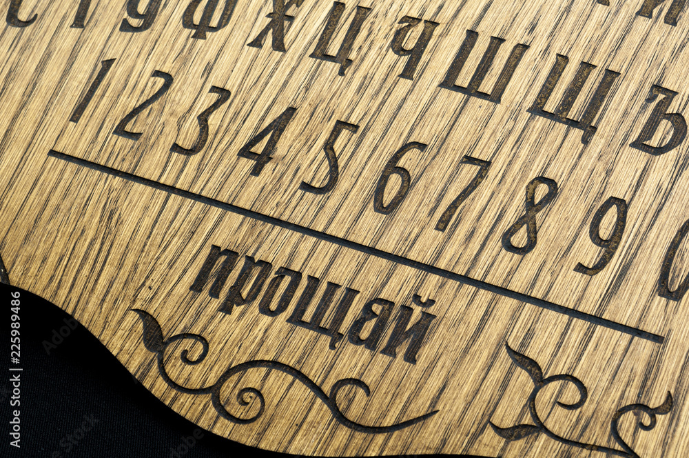 Ouija Board, yellow on a black background