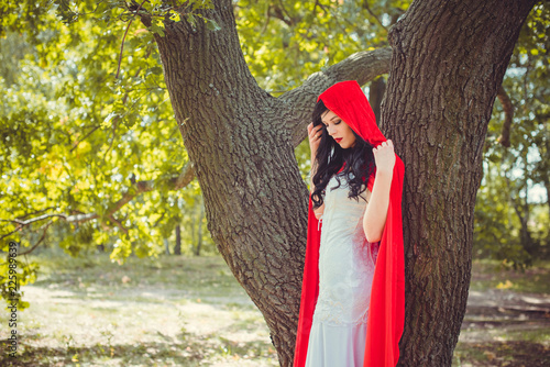 Halloween party concept, mysterious girl in black lace handmade dress and red hood. Beautiful young woman. Inspiration for halloween celebration, ideas and simple nice detail   photo