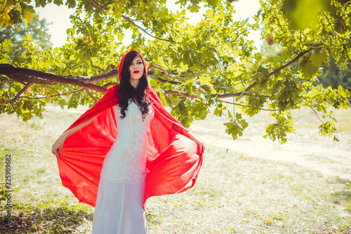 Halloween party concept, mysterious girl in black lace handmade dress and red hood. Beautiful young woman. Inspiration for halloween celebration, ideas and simple nice detail   photo