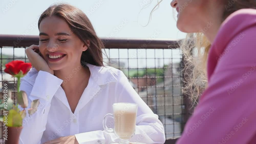 Woman Drinking Coffee At Cafe With Friend Outdoors Woman Drinking Coffee At Cafe With Friend Outdoors