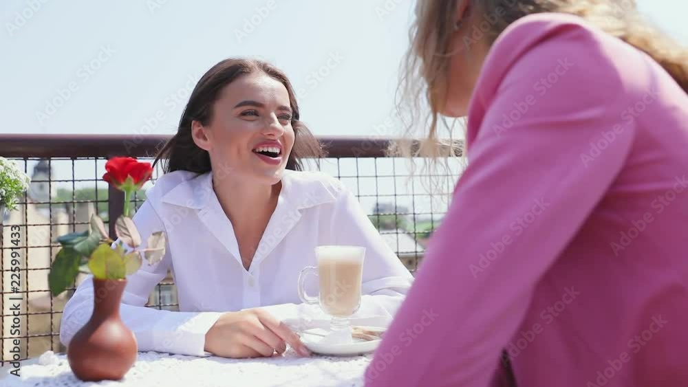 Woman Drinking Coffee At Cafe With Friend Outdoors Woman Drinking Coffee At Cafe With Friend Outdoors