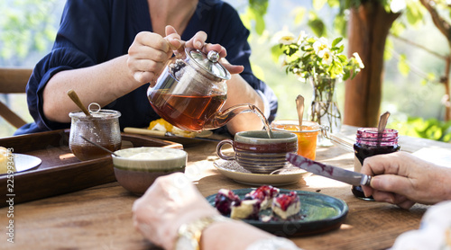 Konstfotografi Daughter pouring hot tea for mother