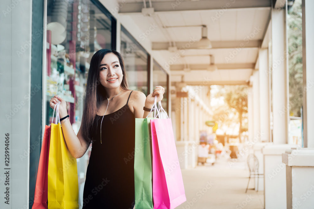 Asian funny woman holding shopping bags. Asian funny woman holding shopping bags.