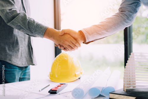 Construction worker greeting a foreman at renovating apartment.