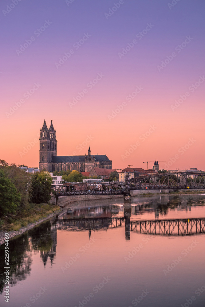 Colorful sunset in front of cathedral and old bridge in Magdeburg, Germany - obrazy, fototapety, plakaty 