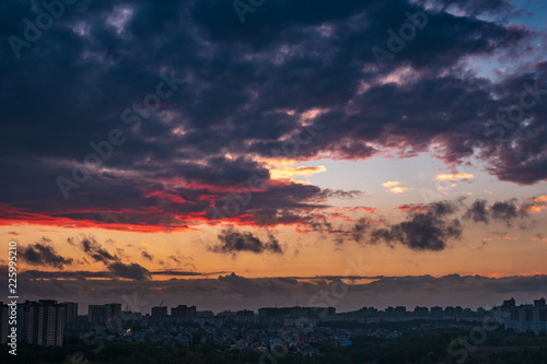 Dramatic colorful autumn clouds at sky over city at sunset  beautiful nature landscape panorama