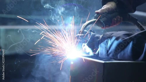Welding of the safe. Electric welding of the safe. Sparks fly. Working room. Natural lighting.