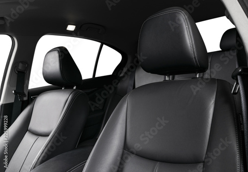 Modern luxury car black leather interior. Part of leather car seat details with stitching. Interior of prestige modern car. Comfortable perforated leather seat. Black perforated leather. Car detailing © Aleksei